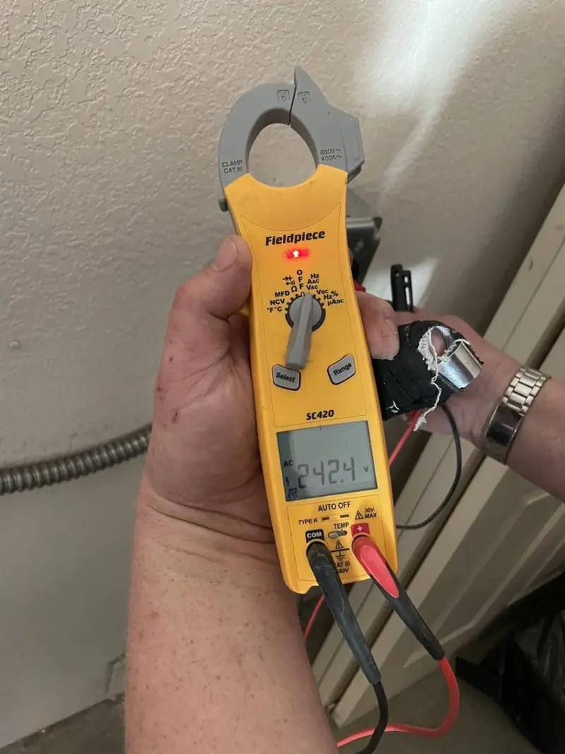 Voltage testing with clamp meter during Recessed Lighting Installation in Belvidere